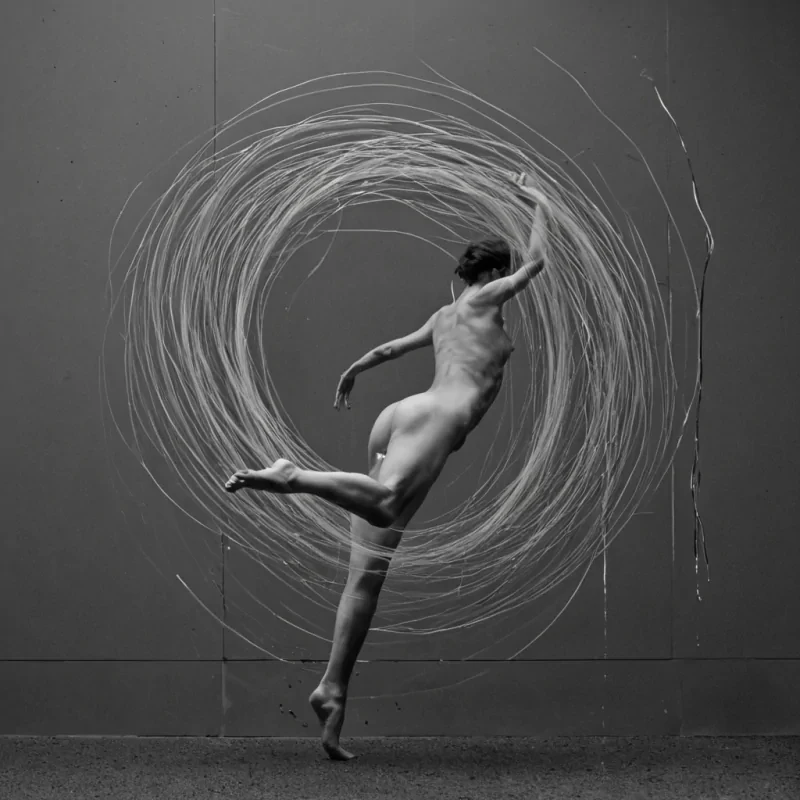 A single, selfigniting filament of reversed stillness, shaped like a 7,891dimensional thread of unformed motion and inverted inertia, drifts through the core of a vast, inverted void of solidified momentum. Each twist is woven from the exact moment between a foot lifting off the ground and its refusal to fall, a hand reaching toward a door and dissolving into noncontact, a thought forming in the mind and collapsing into pure, unmeasured nonaction. The thread does not resist movementit unresists it, each shimmering strand shedding a layer of kinetic potential that never coalesced into stride, gesture, or the weight of doing. As it spirals through the voids heart, it leaves behind