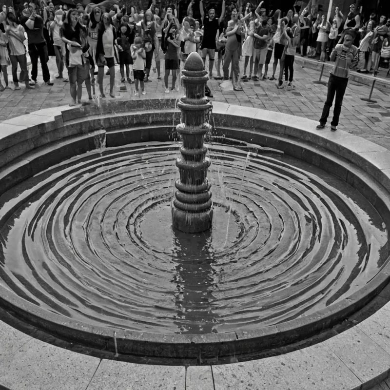 A single, selfsiphoning fountain of reversed laughter, shaped like a 42,789dimensional spiral of unformed mirth and inverted joy, erupts from the center of a vast, inverted plaza of solidified solemnity  each droplet forged from the exact moment between a childs giggle forming in the throat and its refusal to be heard, a shared joke dissolving into nonecho, a hand clapping in celebration and collapsing into pure, unmeasured nonexuberance. The fountain does not release sound  it unreleases it, each glistening arc shedding a layer of emotional resonance that never coalesced into audible delight, reforming into ephemeral, amethystveined afterimages shaped