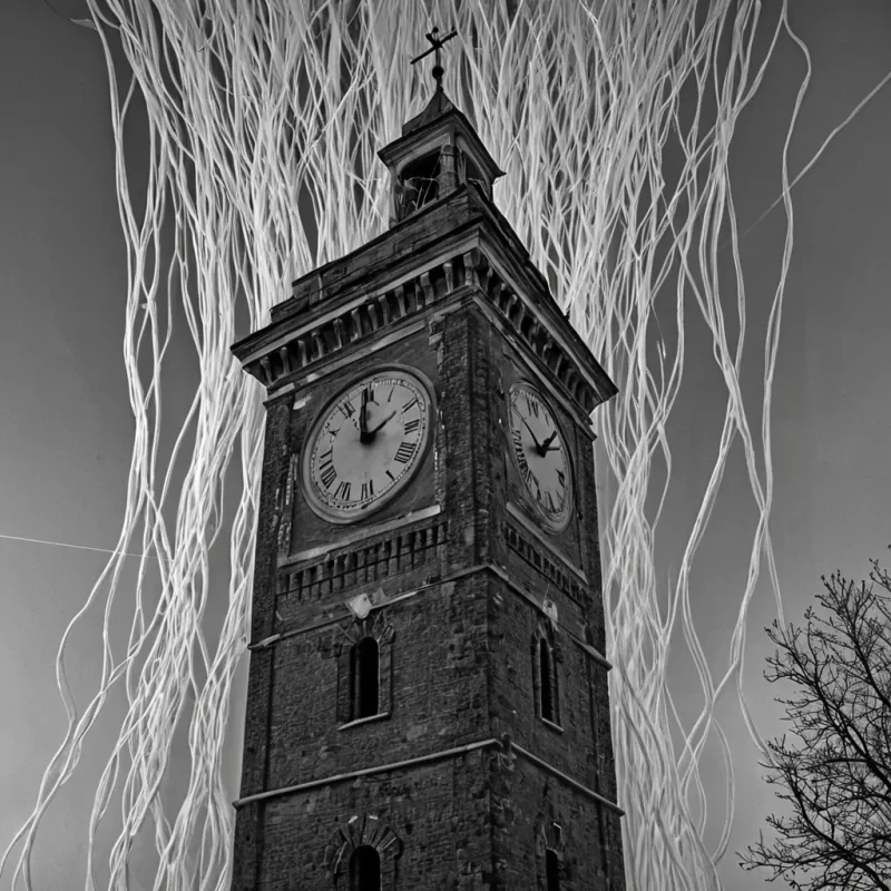 A single, selfilluminating filament of reversed entropy pulses through the core of a floating, inverted clocktower made entirely of solidified timelapse photographs, its structure not metal or brick but woven from the thermal afterimage of a thousand unrecorded moments that never occurred in the lives of a world that never aged. The filament does not tickit unmeasures, each pulse dissolving a second into its original absence, releasing a wave of zeroentropy stillness that fractures the fabric of chronology into a drifting mist of monochrome, geometric instants, each one etched with the chromatic echo of a hand that never pressed a button on a device that never existed. The clocktowers hands are not rotatingthey are frozen